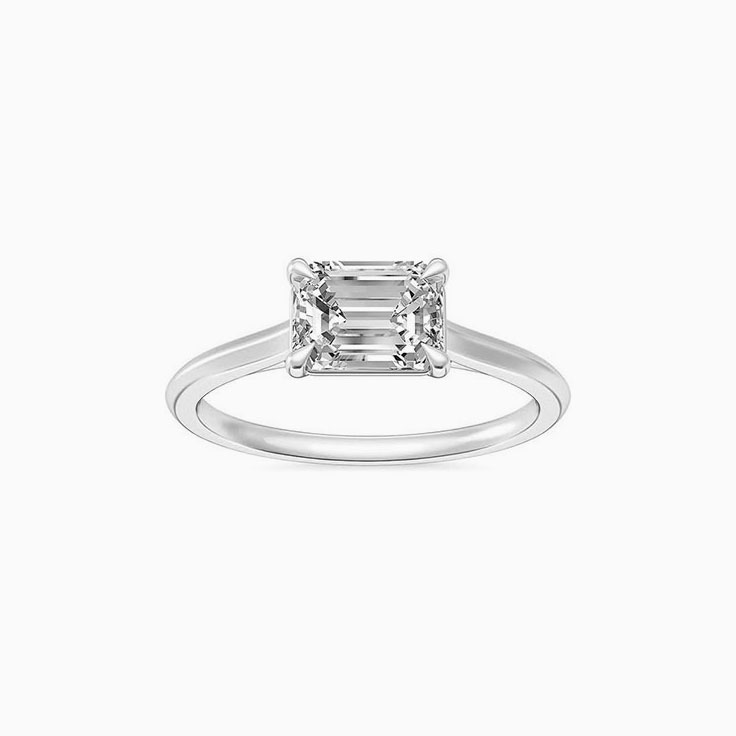East to west emerald engagement ring