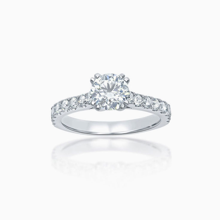 Round brilliant cut engagement ring set with double claws