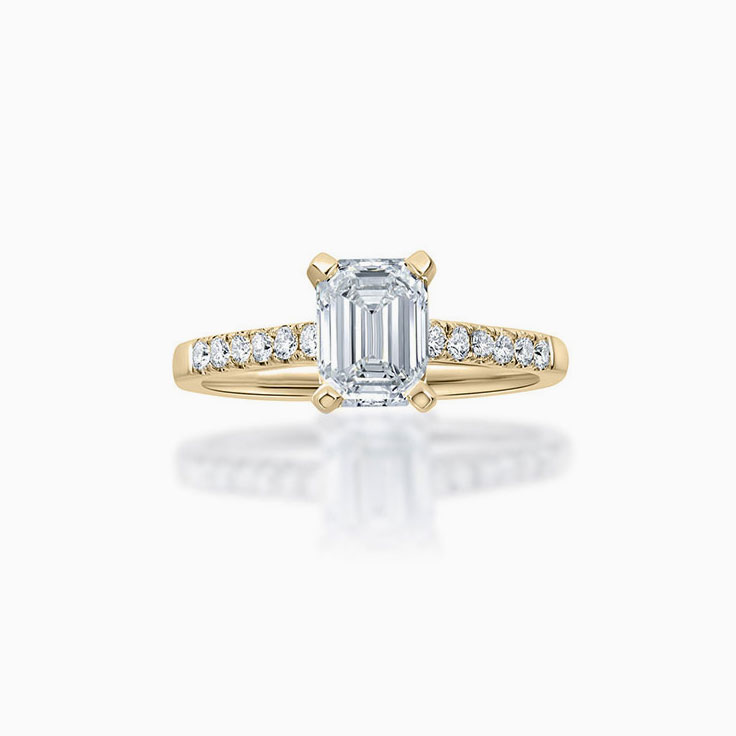 Emerald cut diamond engagement ring on a pave band