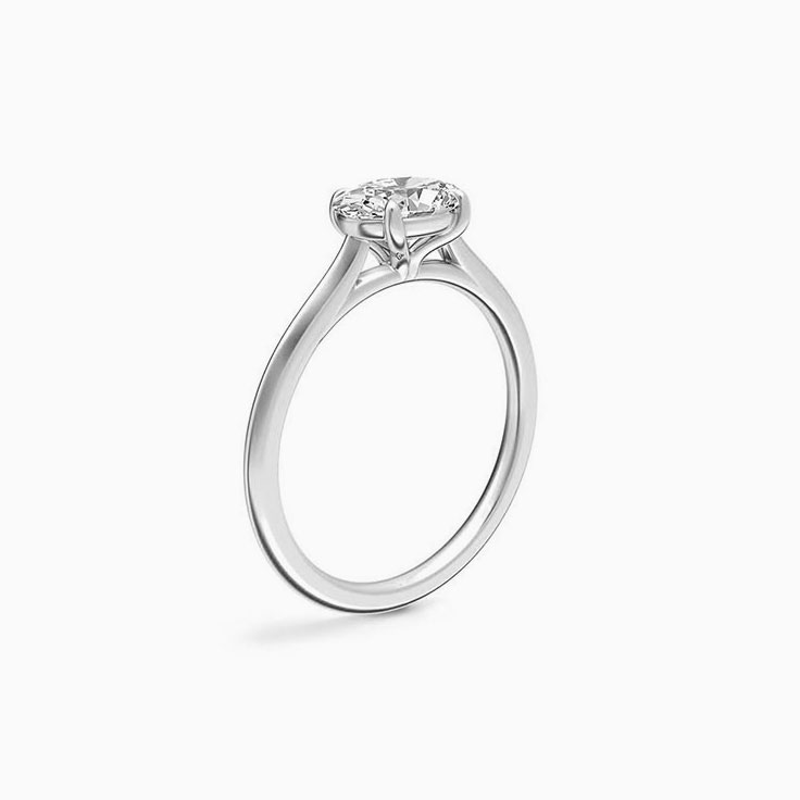 East to west emerald engagement ring